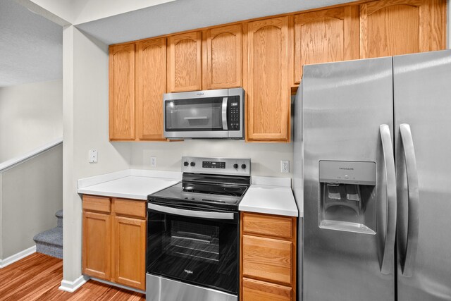 kitchen featuring appliances with stainless steel finishes and light wood-type flooring