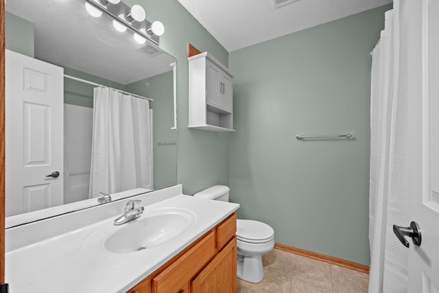 bathroom featuring tile patterned flooring, vanity, a textured ceiling, and toilet