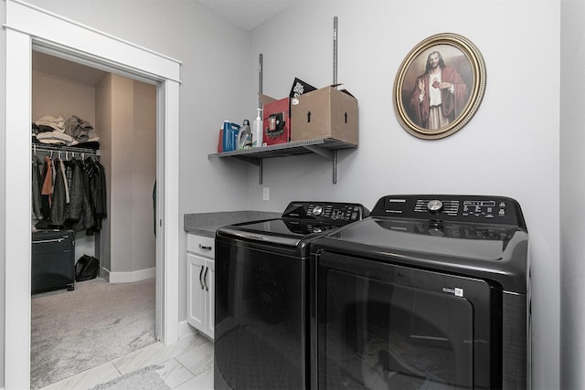 laundry area with cabinets, light colored carpet, and washer and dryer