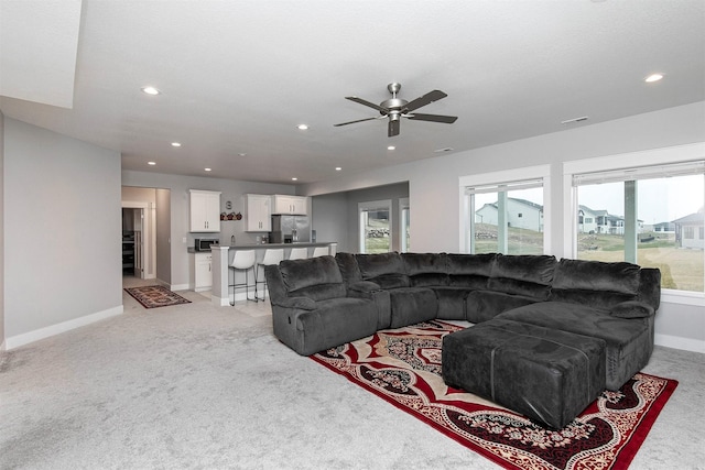 living room featuring ceiling fan and light carpet