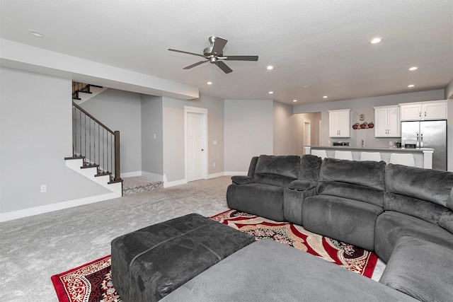 carpeted living room with ceiling fan