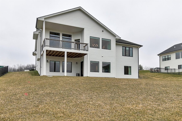 back of property featuring a lawn and a balcony