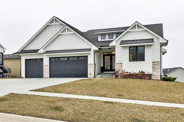 view of front of property featuring french doors, a front lawn, and a garage