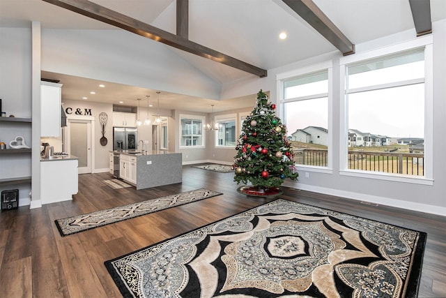 living room with beam ceiling, dark wood-type flooring, and a chandelier