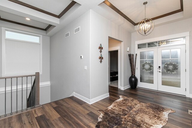 entrance foyer featuring french doors, dark hardwood / wood-style floors, and an inviting chandelier