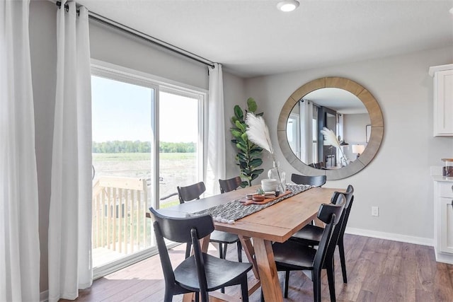 dining space with light hardwood / wood-style flooring