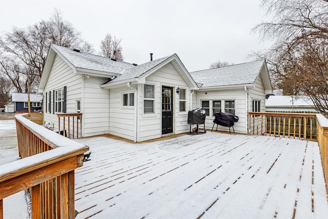 snow covered deck featuring a grill