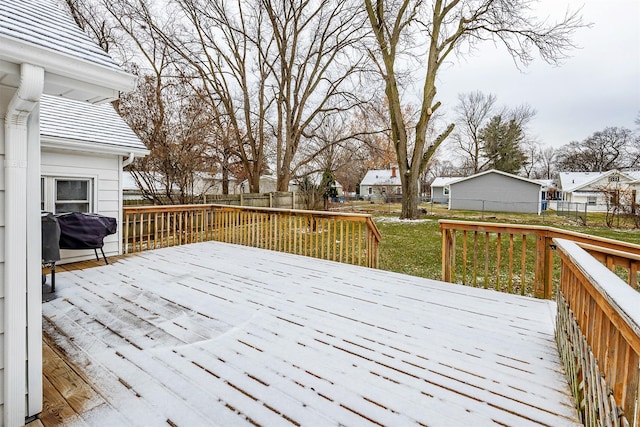 wooden deck with a yard and a grill