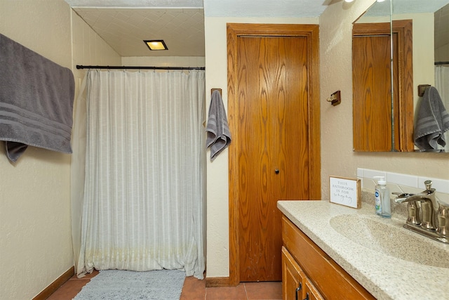 bathroom featuring tile patterned flooring and vanity