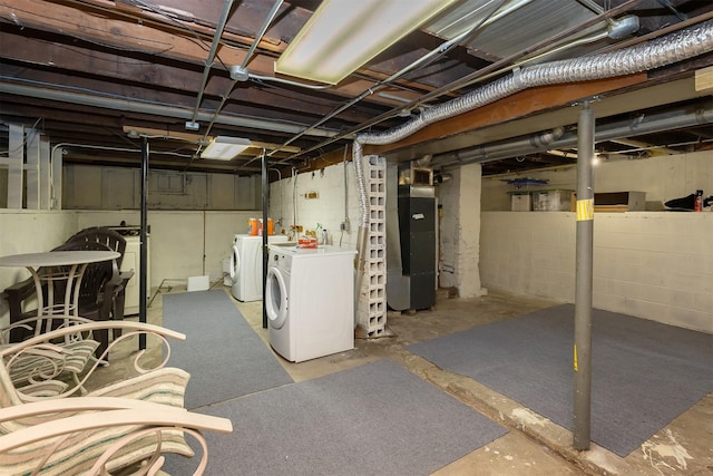 basement featuring heating unit and independent washer and dryer