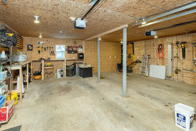 garage with a workshop area and a garage door opener