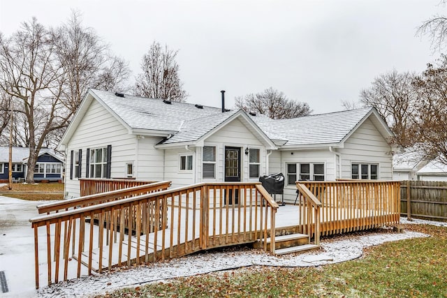 snow covered property with a deck