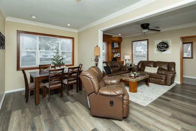 living room featuring ceiling fan, crown molding, and plenty of natural light