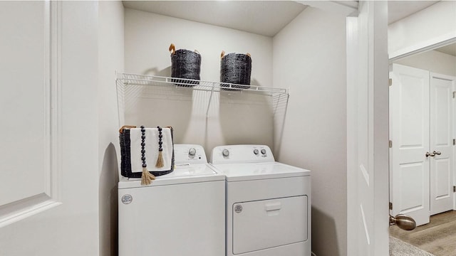 clothes washing area featuring independent washer and dryer and light wood-type flooring