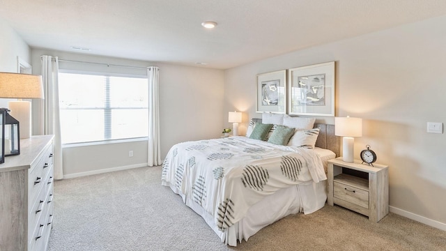 bedroom featuring light carpet and baseboards