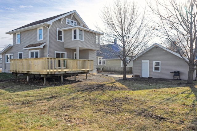 back of house with a yard and a wooden deck