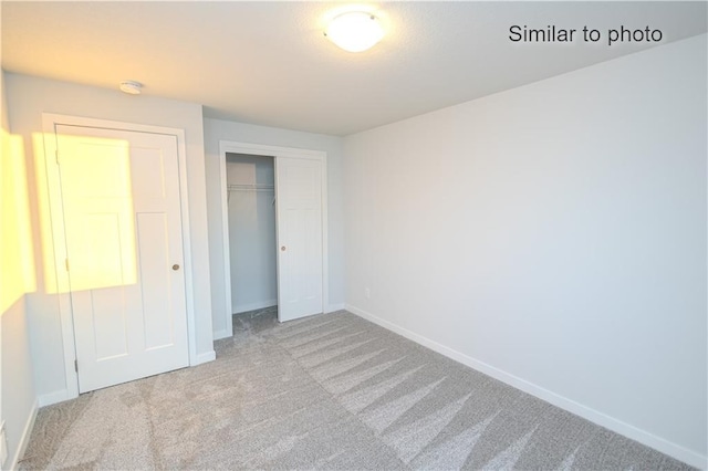 unfurnished bedroom featuring carpet floors and a closet