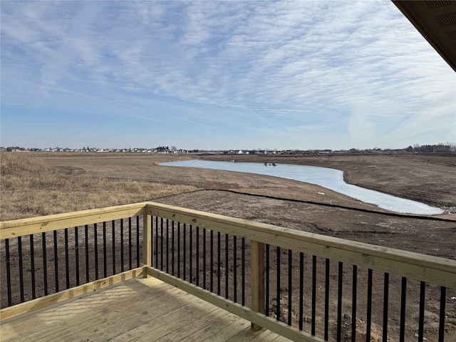 wooden deck with a rural view and a water view