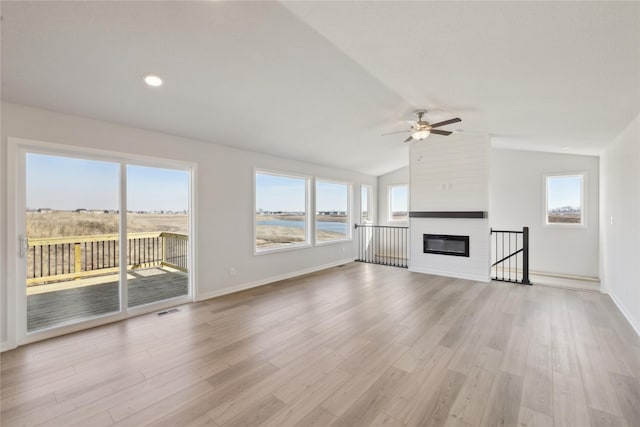 unfurnished living room featuring light wood-style floors and a wealth of natural light