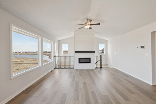 unfurnished living room featuring baseboards, a ceiling fan, lofted ceiling, light wood-type flooring, and a fireplace