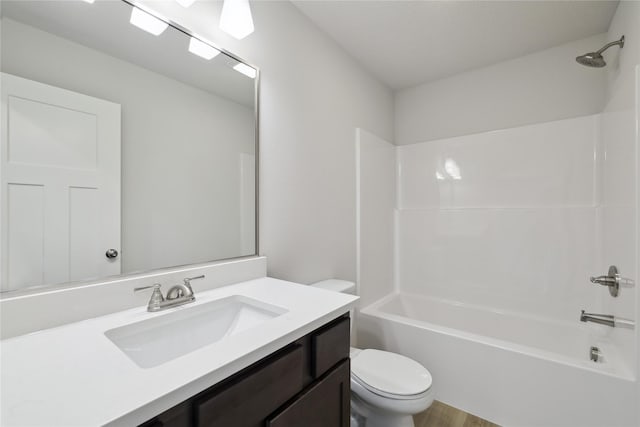 bathroom with toilet, vanity, and shower / bathing tub combination