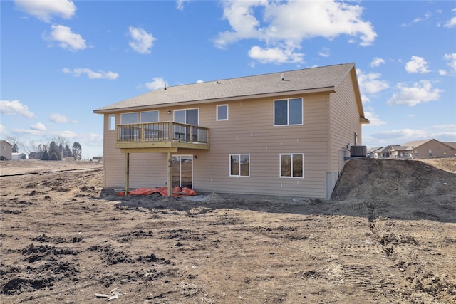 back of house featuring central AC and a balcony