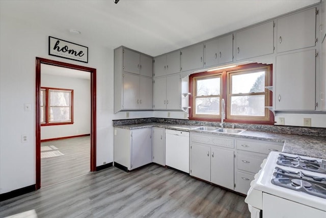 kitchen with gray cabinetry, sink, light hardwood / wood-style floors, and white appliances