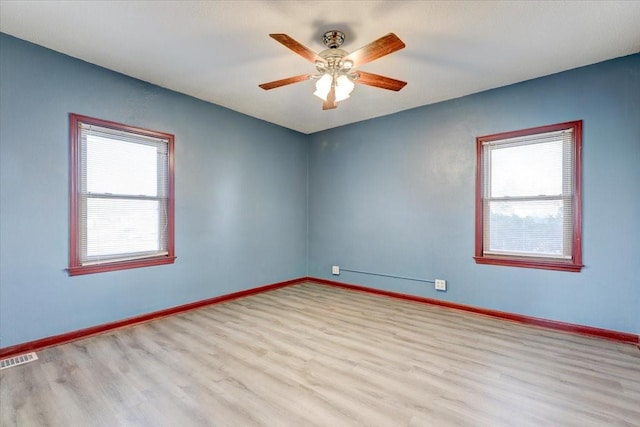 spare room featuring light hardwood / wood-style flooring and ceiling fan