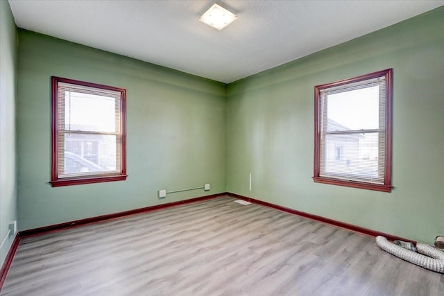 unfurnished room with light wood-type flooring