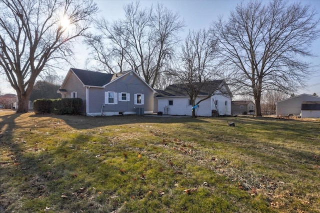 rear view of house with a yard