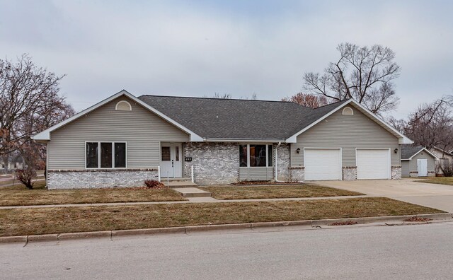 ranch-style home featuring a front lawn and a garage