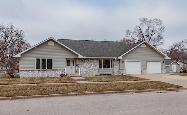 single story home featuring a garage, a shingled roof, concrete driveway, a front lawn, and brick siding