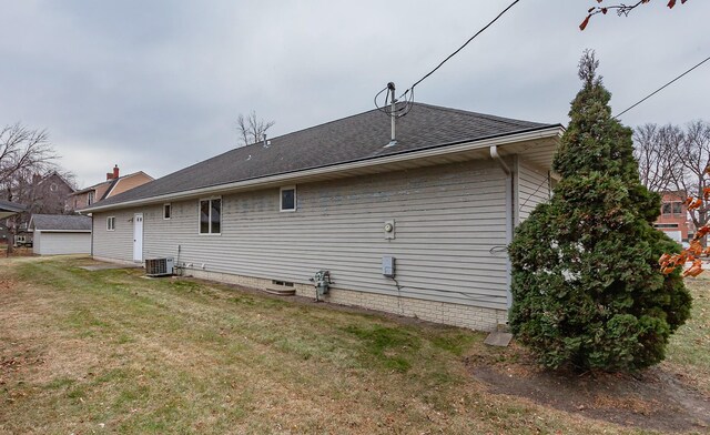 back of house featuring central AC and a lawn