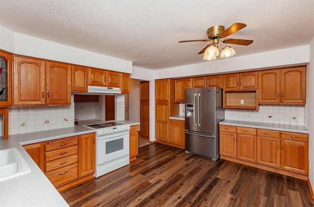 kitchen with dark wood-type flooring, high end fridge, ceiling fan, decorative backsplash, and white range with electric stovetop