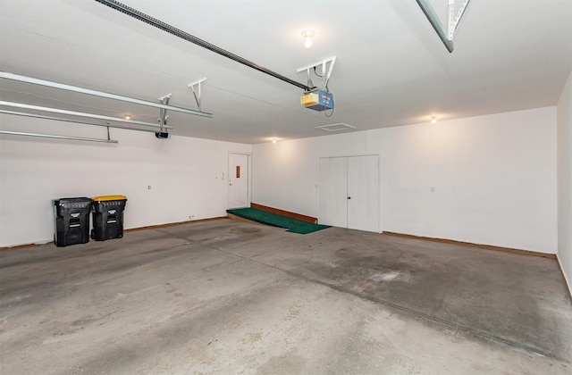 garage with baseboards and a garage door opener