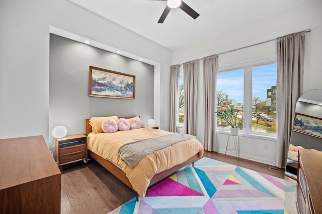 bedroom with dark hardwood / wood-style floors and ceiling fan