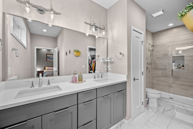 bathroom featuring toilet, vanity, and walk in shower