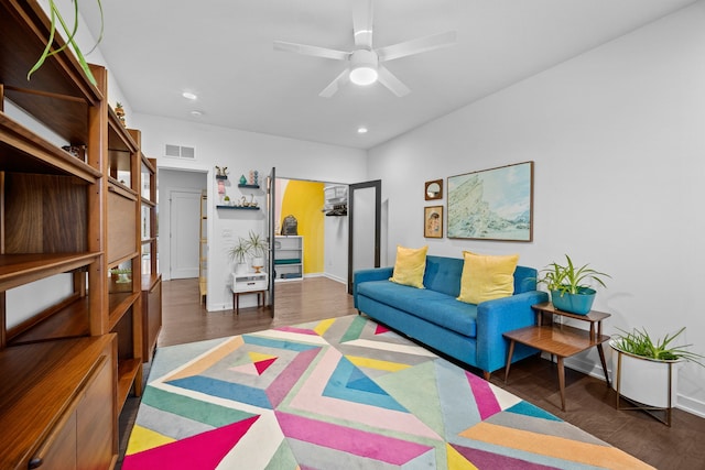 living room with dark hardwood / wood-style floors and ceiling fan