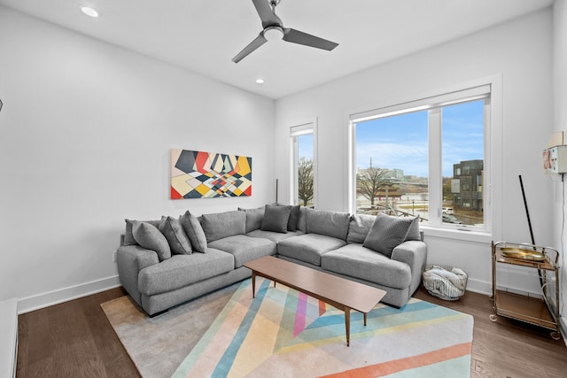 living room featuring ceiling fan and hardwood / wood-style floors