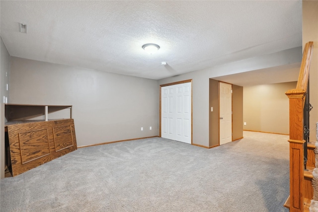 unfurnished bedroom featuring carpet flooring and a textured ceiling