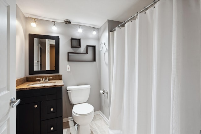 bathroom featuring vanity, tile patterned flooring, and toilet