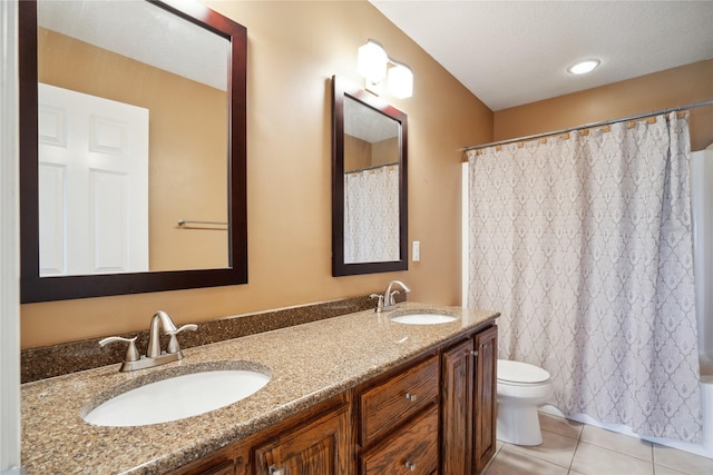 bathroom featuring vanity, toilet, and tile patterned flooring