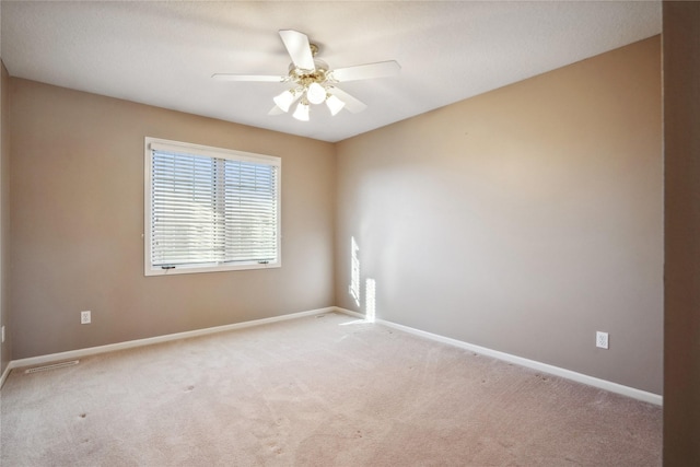 unfurnished room featuring light carpet and ceiling fan