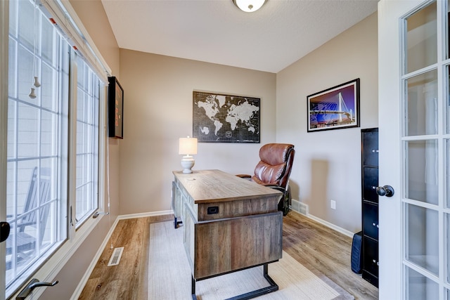 office featuring light wood-type flooring and french doors