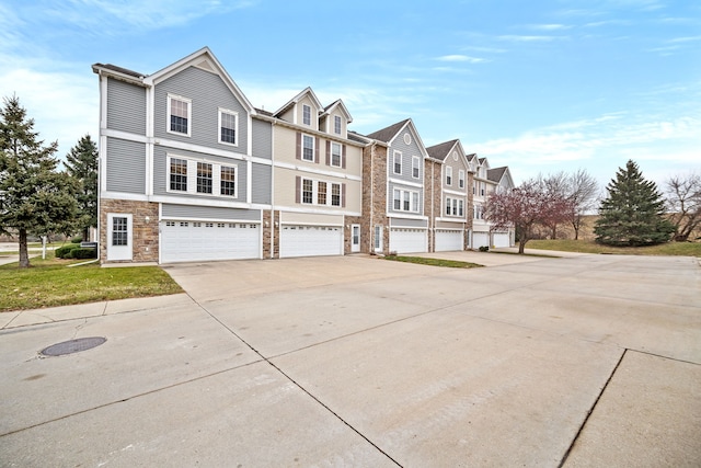 multi unit property with a garage and concrete driveway