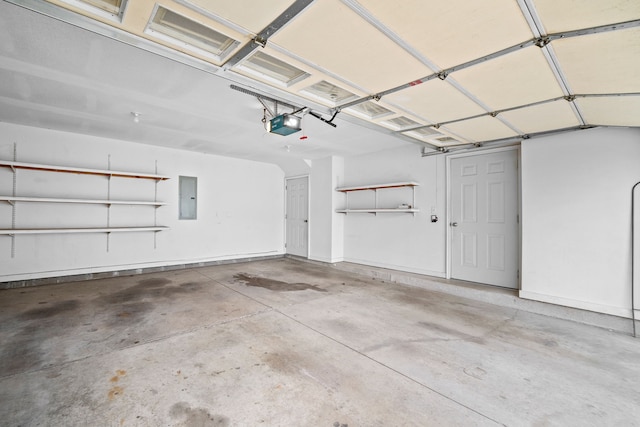 garage featuring baseboards, electric panel, and a garage door opener