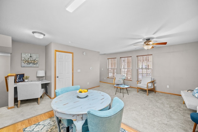 dining space with ceiling fan, light wood-type flooring, and baseboards