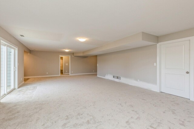 empty room featuring light carpet and plenty of natural light