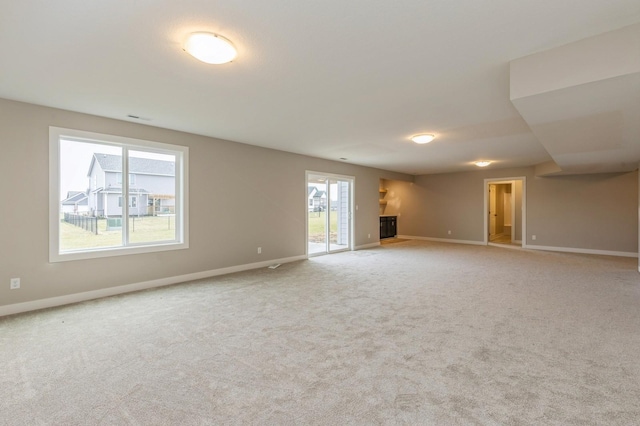 unfurnished living room with light colored carpet