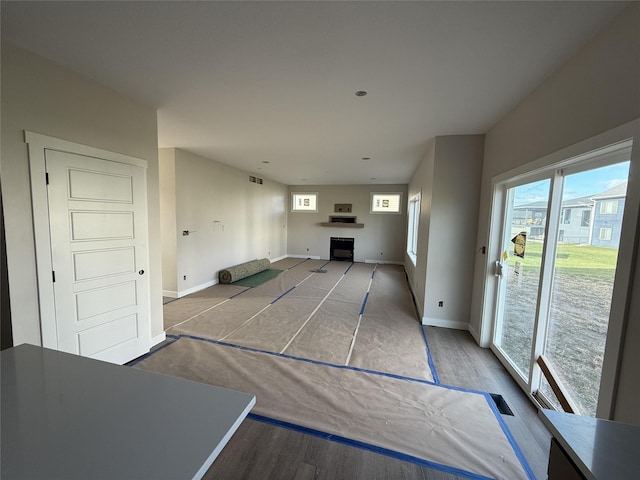 unfurnished living room featuring a fireplace and hardwood / wood-style floors